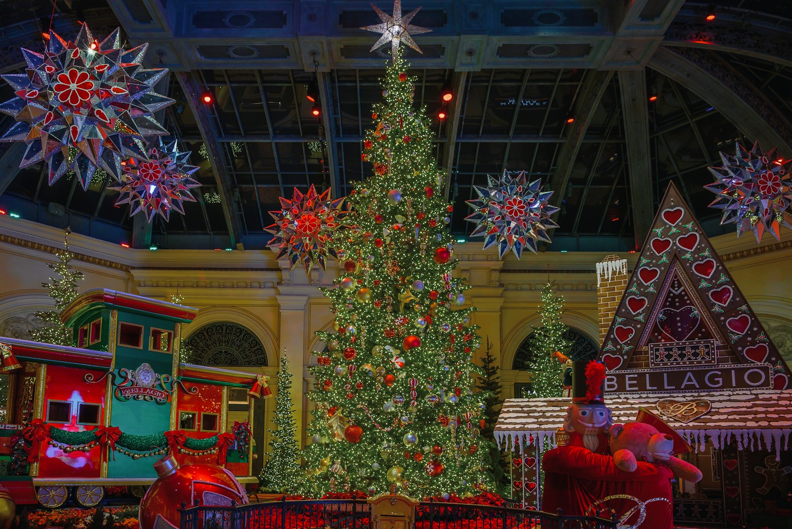 A festive christmas tree with train and decorations