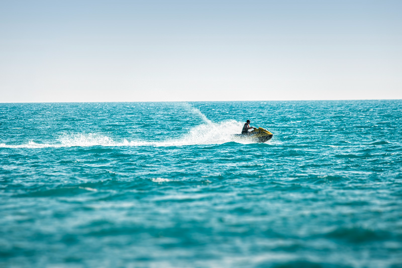 man surfing on sea waves during daytime